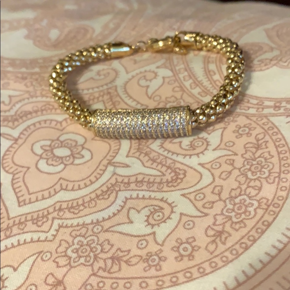 Goldtone bracelet with barrel of clear pave stones
